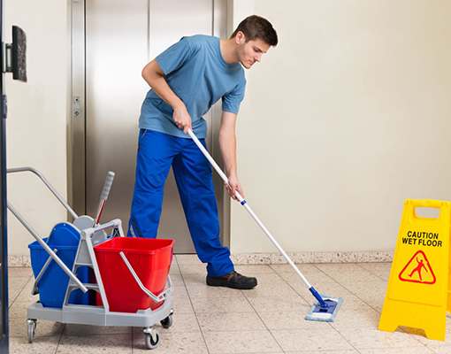 a service man is cleaning the floor with mop