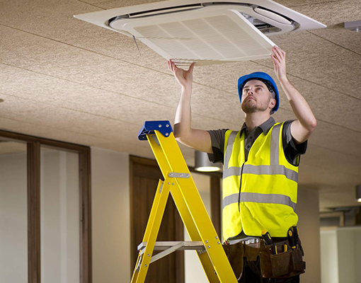 a man is fixing false ceiling